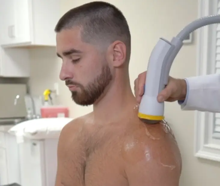 SoftWave Therapy device used in an in-home session by Health Plus Mobile, South Charlotte NC