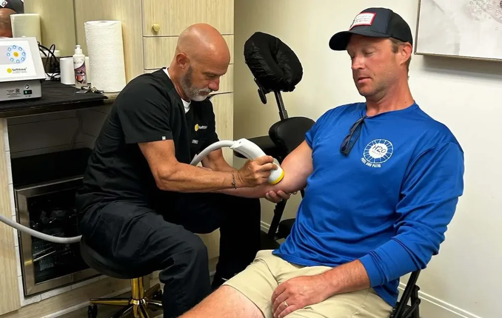 Is SoftWave Therapy safe? Provider performing SoftWave Therapy on a patient's elbow during an in-office session.