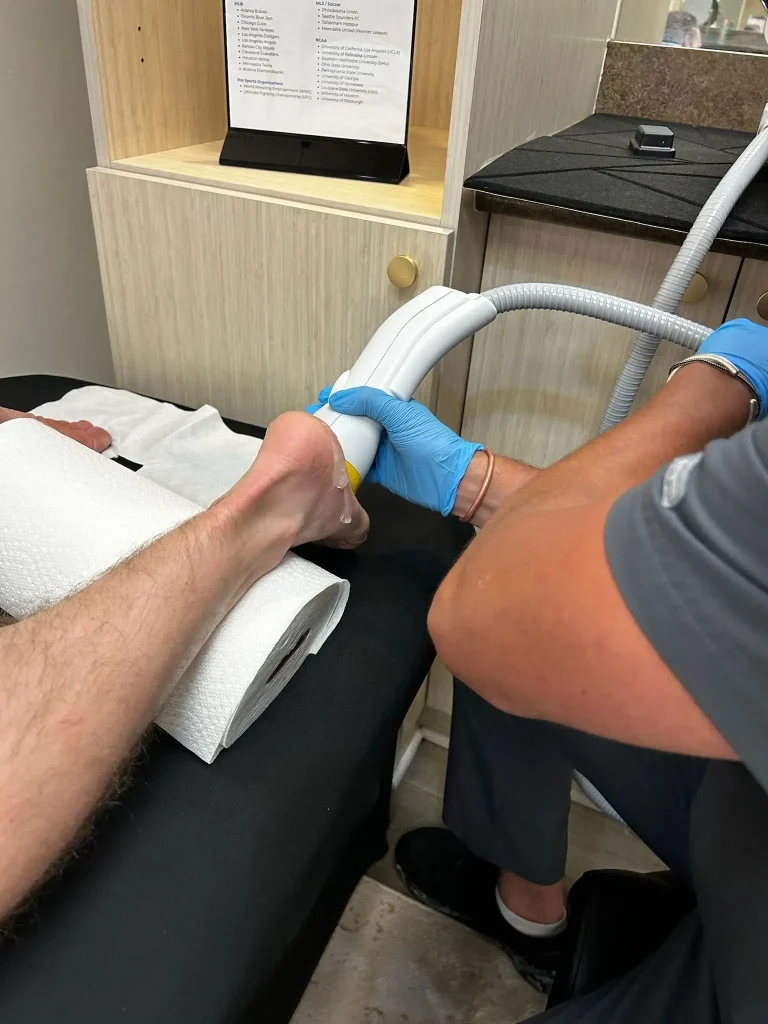 Is SoftWave Therapy safe? Close-up of SoftWave Therapy being applied to a patient's heel for foot pain treatment.