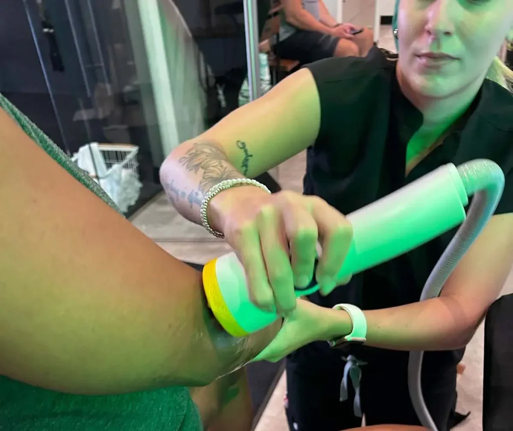SoftWave vs shockwave therapy for elbow pain during a non-invasive treatment session at a chiropractic clinic