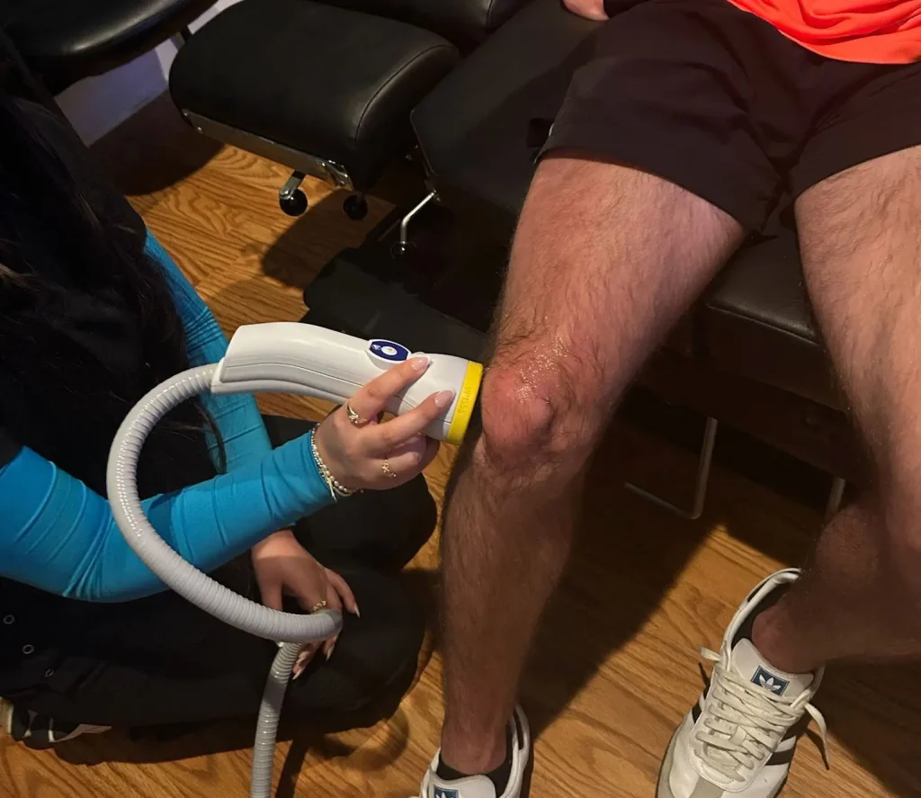 SoftWave vs shockwave therapy for knee pain with a provider using acoustic wave treatment on the patient's knee